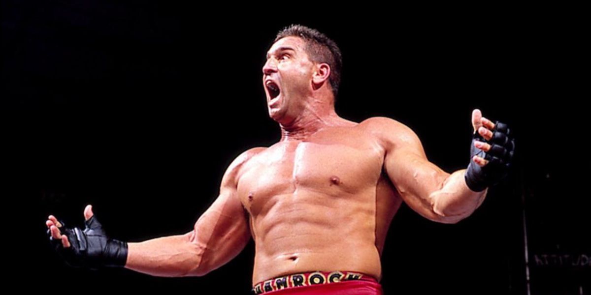 Ken Shamrock lets out a huge yell, with his mouth hung open crazily.